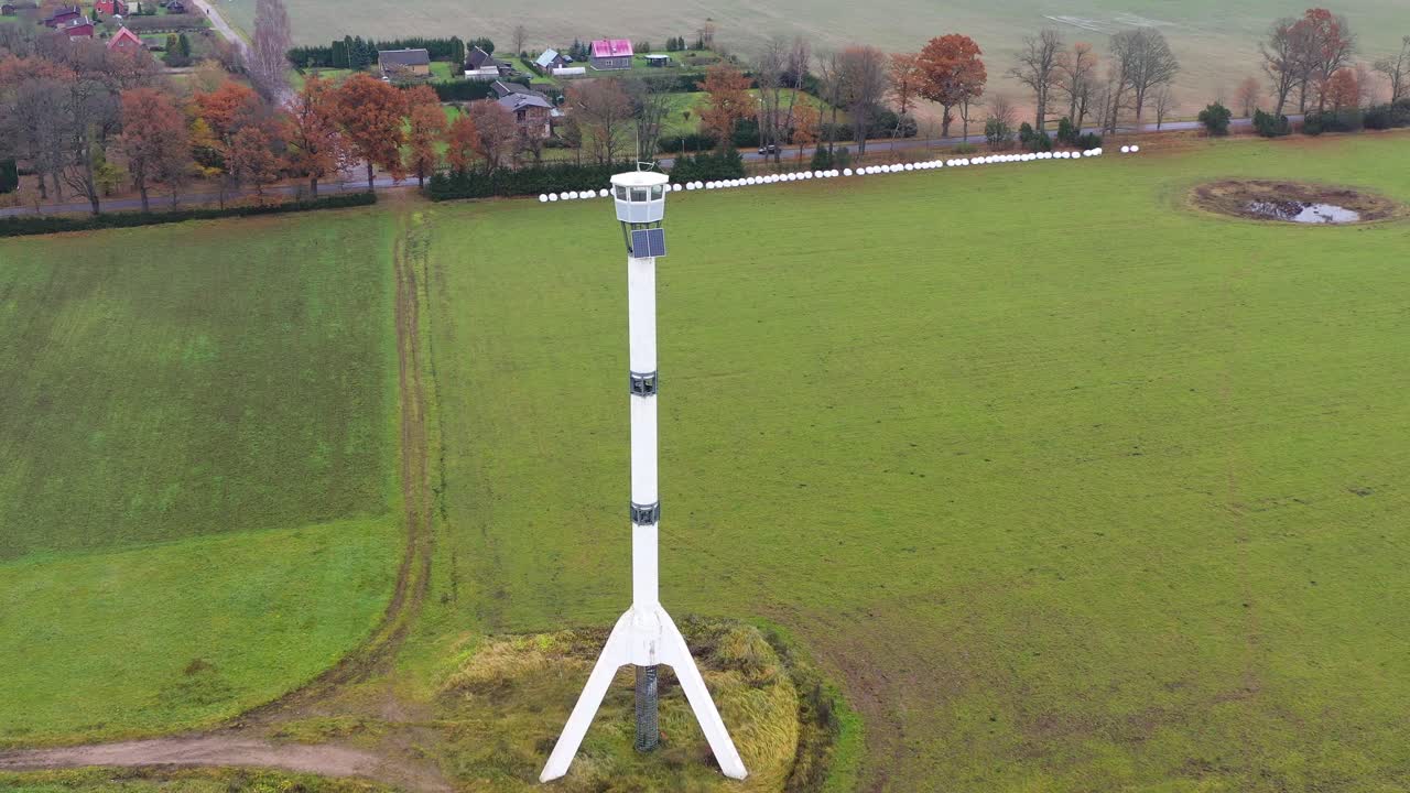 Huge firefighters observation tower in rural fields, aerial drone view