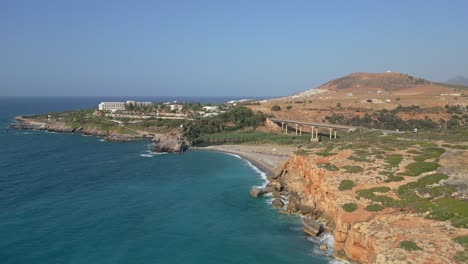 cinematic footage of geropotamos coastline and beach in crete, with the iconic bridge in the background over the blue sea