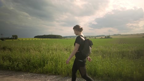 moody cloudy skies, female brunette, countryside location, slow motion