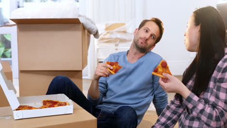 couple having pizza in new house 4k