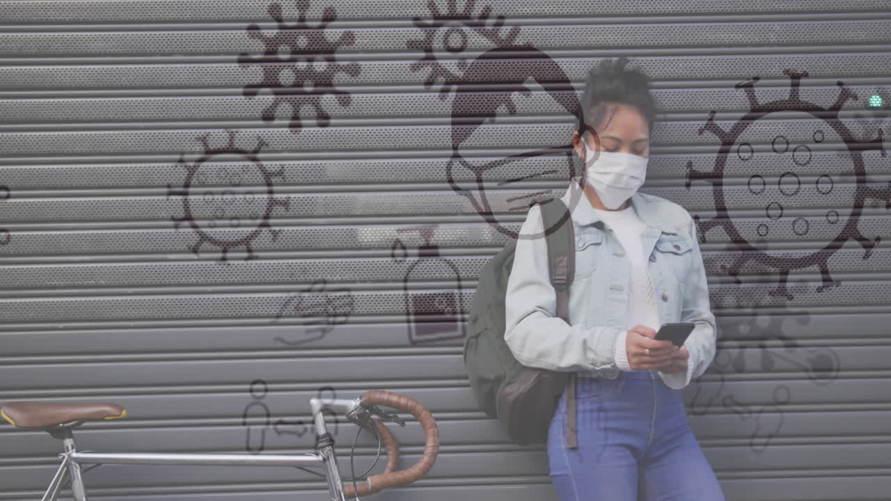 Coronavirus concept icons against woman wearing face mask using smartphone