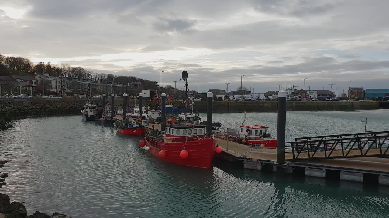 Small pier with fisher boats in Howth