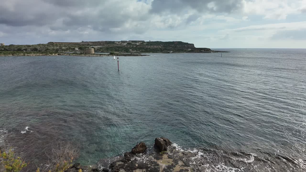Scenic View of a Coastal Fortress and Sailboats on a Calm Sea