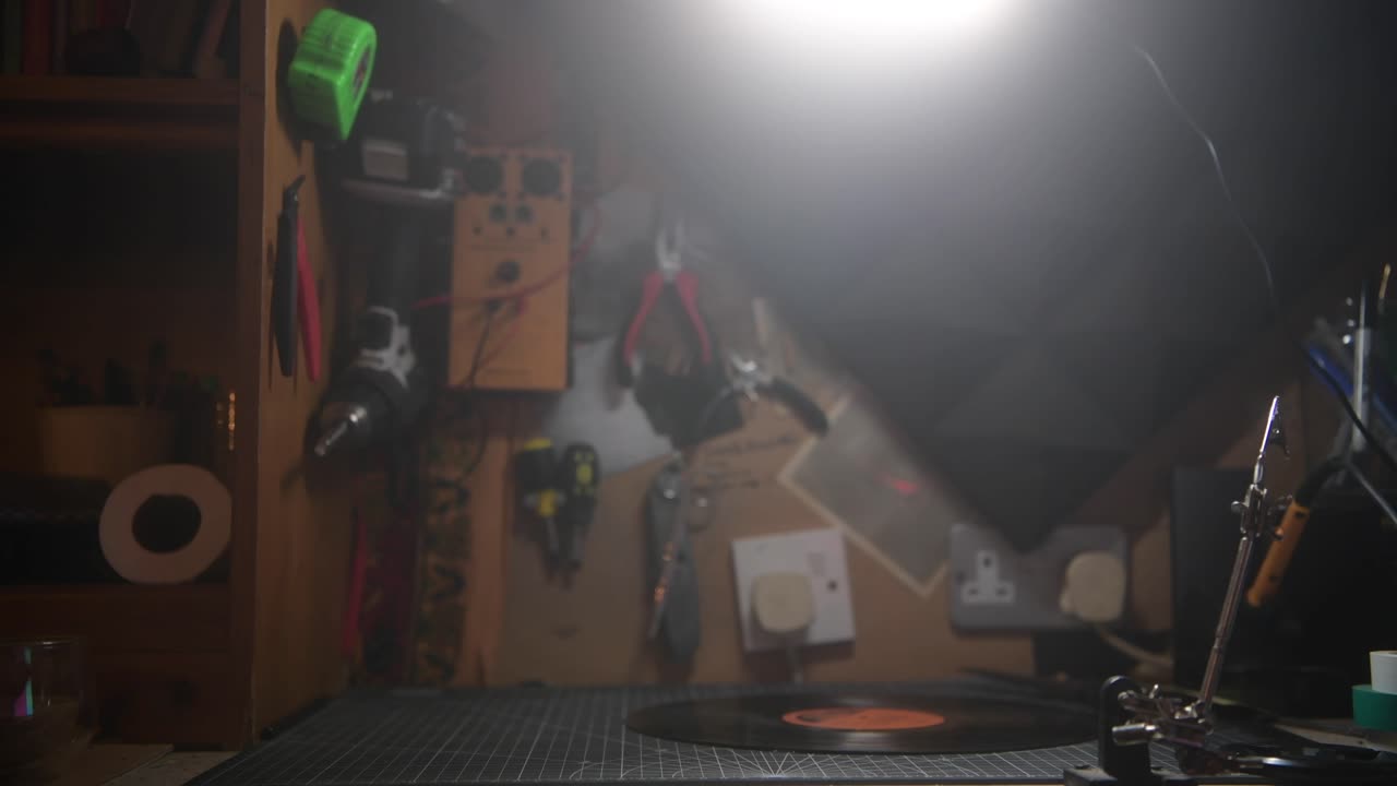 Vintage record player vinyl disc spinning on the work bench table top