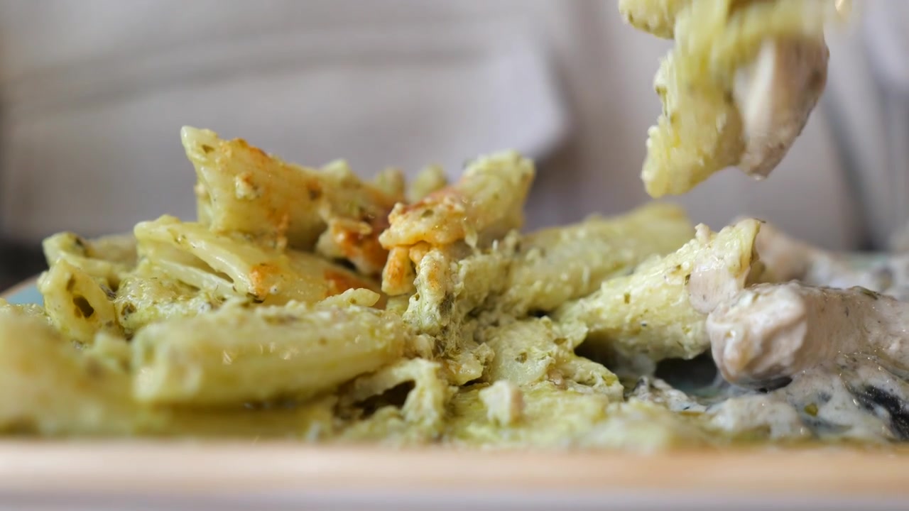 Fork Picking Up Delicious Pesto Pasta with Chicken