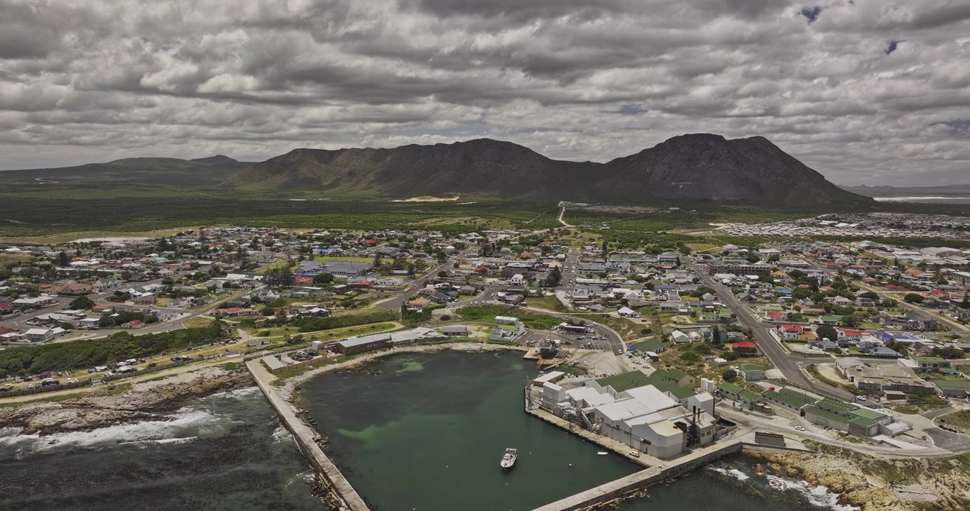 Gansbaai Etelä-Afrikka, ilmakuvaus v22 ylilento sataman, kaupungin keskustan ja asuinalueiden ympärillä rannikkovuoristonäkymillä – Kuvattu Mavic 3 Pro Cine -kameralla – 8. tammikuuta 2024.