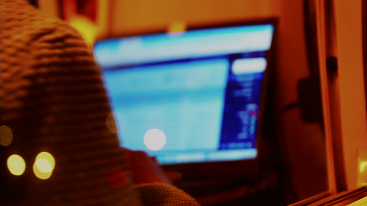 Blurred view of a man working on his laptop in a train