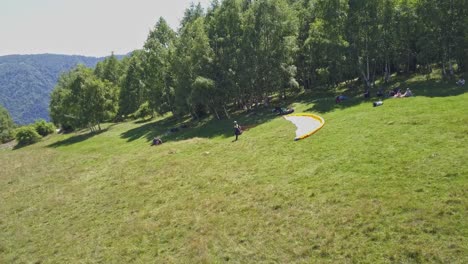 An-adventurer-stands-on-the-launch-site-preparing-for-flight-while-paragliding