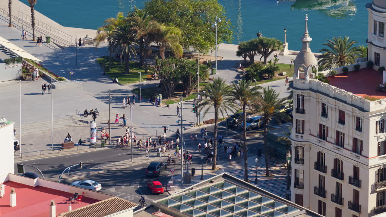 Elegant Casa Carbonell with its domed corner towers framed by palm trees, turquoise marina waters and moored yachts behind