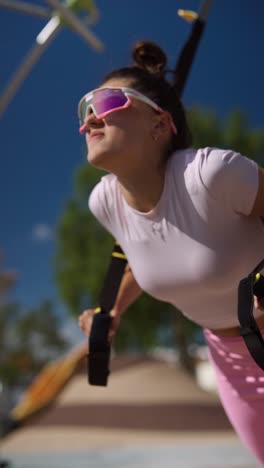 woman exercising with suspension trainer