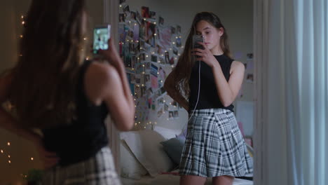 beautiful teenage girl taking selfie photo using smartphone posing in mirror sharing stylish fashion on social media enjoying weekend at home teen self image