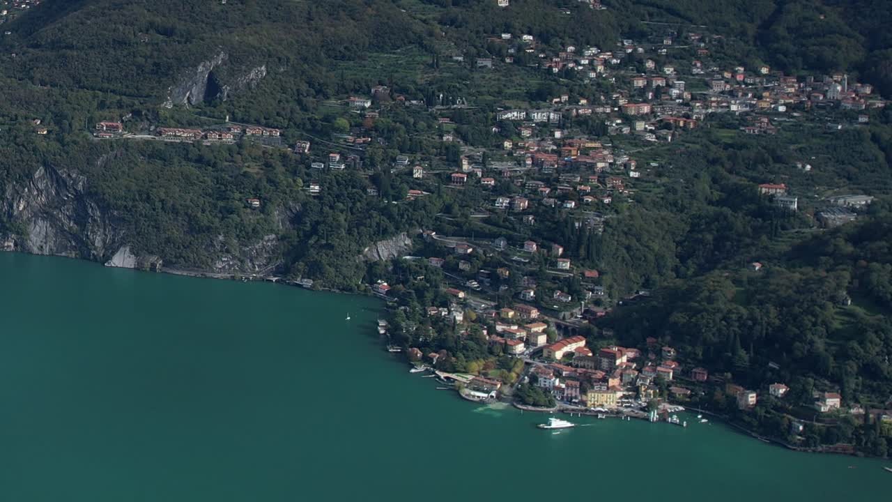 Aerial view of a charming village by the lake in the Italian Alps