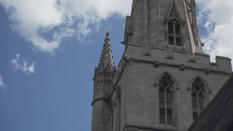 Beautiful-view-of-the-twoer-of-majestic-church-in-Cambridge-city,-England,-blue-sky-and-white-clouds-in-the-background