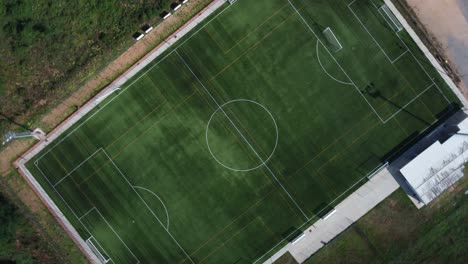 aerial drone view of vibrant green football field in gualba, 4k