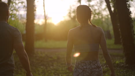 couple exercising in the park at sunrise