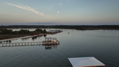 Aerial-view-approaching-Pelican-Point-on-Mobile-Bay,-Alabama-at-Sunset