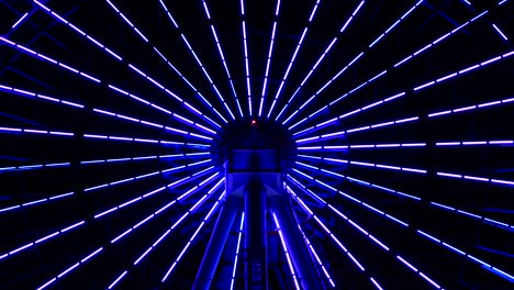 una rueda gigante en movimiento en el parque de atracciones en odaiba tokyo por la noche