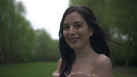 close up shot of an attractive and carefree brunette latina woman sending kisses to the camera