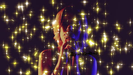 teenage singer holding microphone in dark studio, showing entertainment with light particles