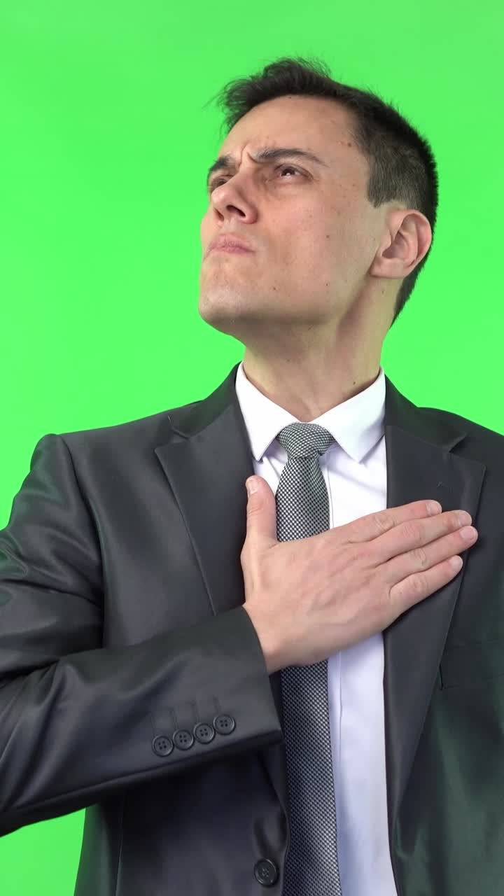 Man in Suit Expressing Skepticism and Respectful Gesture on Green Screen