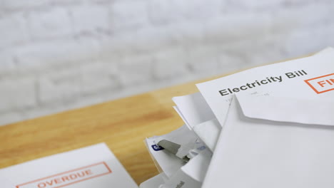 close up of a pile of bills and letters with an electricity bill final notice