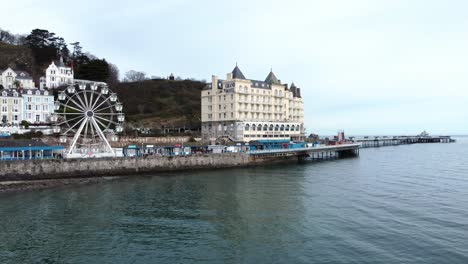 Llandudno-pier-Victorian-promenade-Ferris-wheel-attraction-and-Grand-hotel-resort-aerial-reverse-view