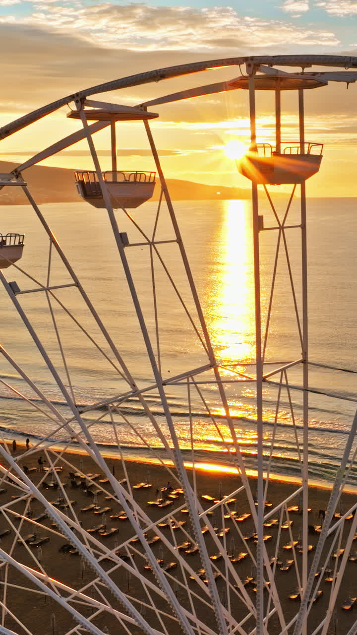 Aerial drone view of a ferris wheel Sunny Beach resort in Bulgaria at sunset. Vertical