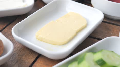 butter and cucumber slices on a plate