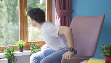 worried and nervous man at home watching outside.