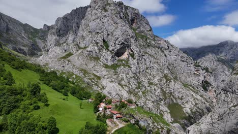 Bulnes-mountain-village-Picos-de-Europa,-Spain-pull-back-drone-aerial-reverse-reveal