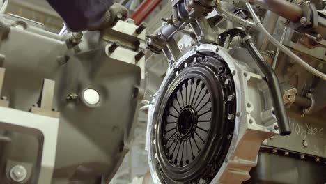 close-up of large part of factory machine on background of factory and workers. scene. part of circular machine that rises to background of modern enterprise