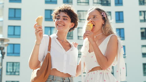 two happy friends enjoying ice cream in the city