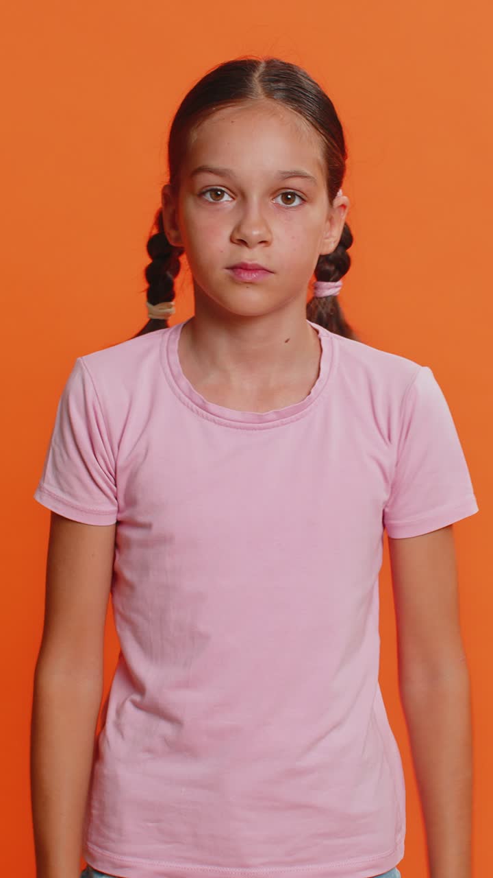 Upset preteen child girl showing thumbs down dislike bad work disapproval dissatisfied feedback