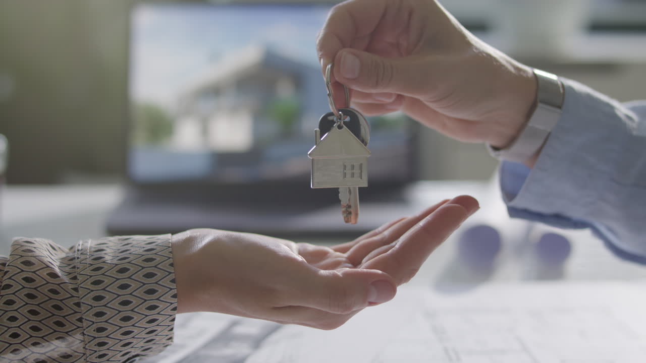 Property Buyer Receiving Keys from Seller during Real Estate Handover