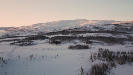 pristine arctic landscape covered in snow, kvaloya, tromso - aerial view