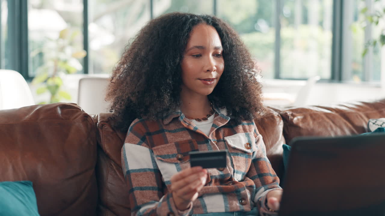 Woman Shopping Online with Credit Card on Laptop