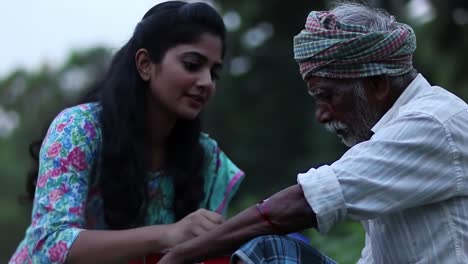 in a tranquil park during dusk, a young woman offers care to an elderly man, showing compassion and connection across generations in a peaceful environment.