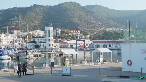 port-town-view-as-couple-with-dog-stop-to-take-picture-during-sunny-morning