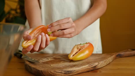 crop teenager removing seeds from pepper