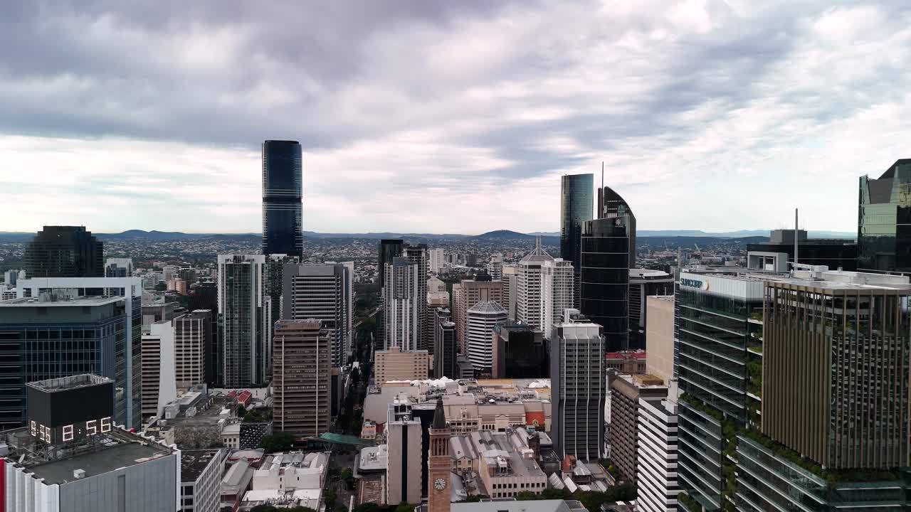 Slow reveal of the towering urban skyline of Brisbane City metropolitan area. Aerial drone view