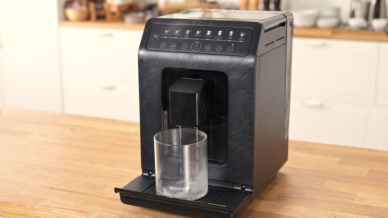 Express cleaning of a black coffee machine on a table, indoor, medium shot, static