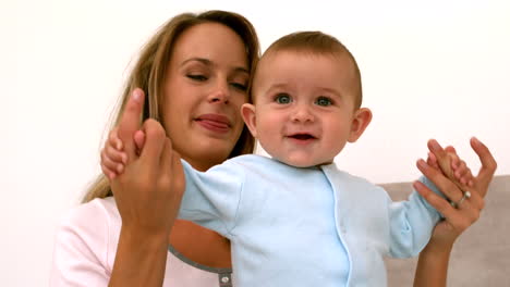 Baby-playing-with-mother-on-bed