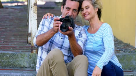 couple looking at photographs in digital camera