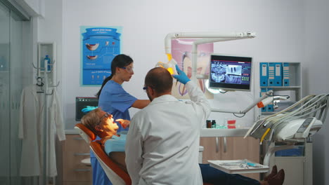 professional dentist working with gloves during examination