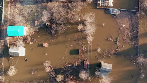 close-up breaking a dam at a hydroelectric plant. streets and buildings of the town are flooded with dirty water. property insurance concept.