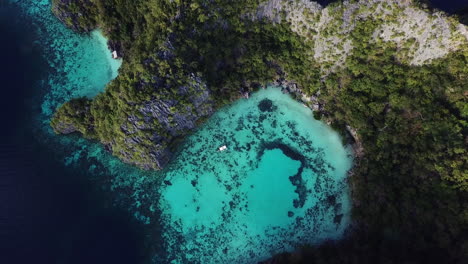 aerial rising view of majestic cliffs and turquoise ocean waters