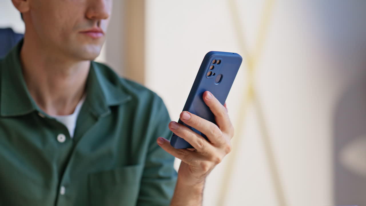 Manager surfing internet smartphone looking information at office space closeup