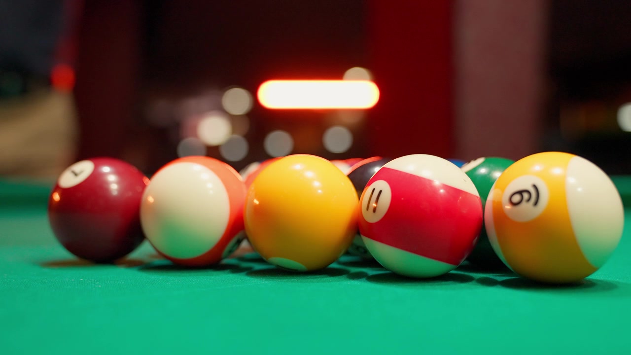 Racking Colorful Billiard Balls on a Green Pool Table
