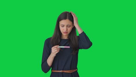 Sad-Indian-girl-checking-pregnancy-test-Green-screen