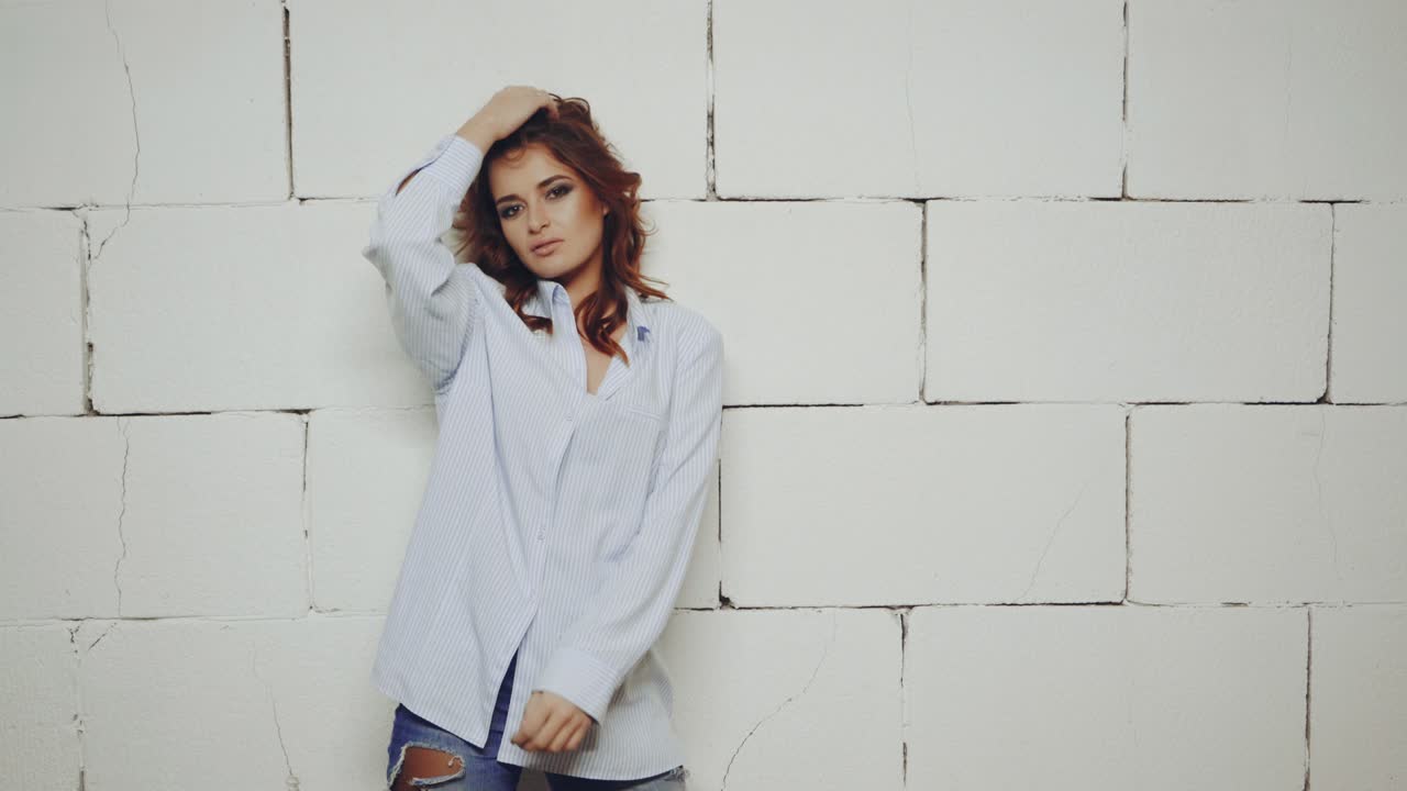 Stylish wearing woman. Young sexy woman posing in style clothes on background in studio